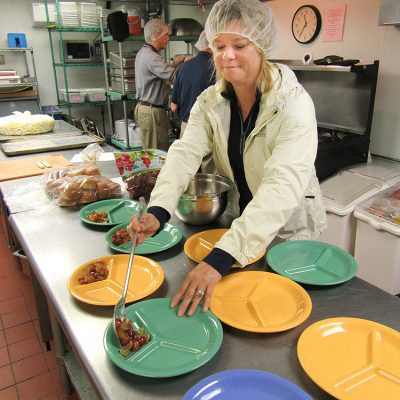 Kim Storey helping serve lunch at Crisis Nursery