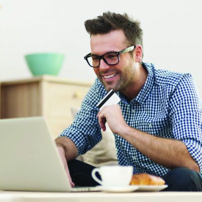 Man using ATM/Debit Card to make online purchases